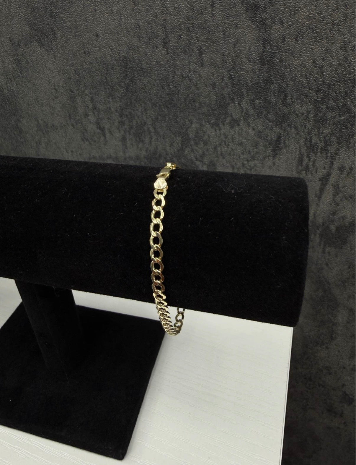 10K gold bracelet, 8 inches long and 4.5 mm wide.